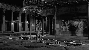 Movie still from “Down by Law” (1986), directed by Jim Jarmusch – A man standing in the middle of an empty street at night; Wide shot, Low angle