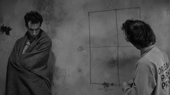 Movie still from “Down by Law” (1986), directed by Jim Jarmusch – Two people standing in front of a wall covered in graffiti; Medium shot, Overhead angle