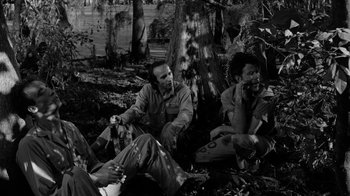 Movie still from “Down by Law” (1986), directed by Jim Jarmusch – A black and white photo of two men sitting on the ground; Medium shot, High angle