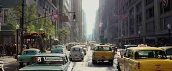 Movie still from “Down with Love” (2003), directed by Peyton Reed – A city street filled with lots of traffic; Extreme Wide shot, High angle