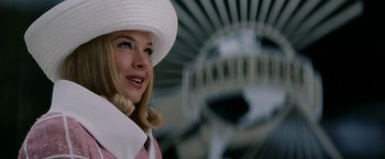Movie still from “Down with Love” (2003), directed by Peyton Reed – A woman wearing a white hat standing in front of an airplane; Close Up shot, Low angle