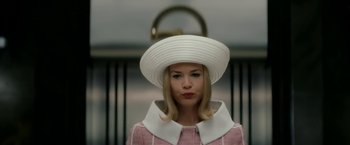 Movie still from “Down with Love” (2003), directed by Peyton Reed – A woman wearing a white hat and a pink coat; Close Up shot, Low angle