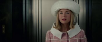 Movie still from “Down with Love” (2003), directed by Peyton Reed – A woman wearing a white hat and a pink dress; Close Up shot, Low angle