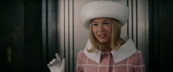 Movie still from “Down with Love” (2003), directed by Peyton Reed – A woman wearing a white hat and a pink coat; Close Up shot, Low angle