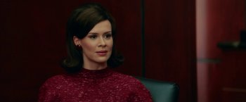 Movie still from “Down with Love” (2003), directed by Peyton Reed – A woman sitting in a chair wearing a red sweater; Close Up shot, Over the shoulder angle