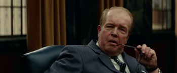 Movie still from “Down with Love” (2003), directed by Peyton Reed – An older man wearing a suit and tie; Close Up shot, Over the shoulder angle