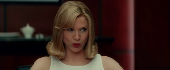 Movie still from “Down with Love” (2003), directed by Peyton Reed – A woman with blonde hair wearing a white top; Close Up shot, Low angle