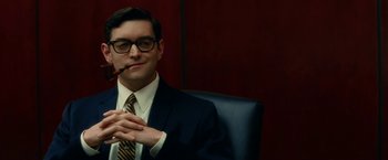 Movie still from “Down with Love” (2003), directed by Peyton Reed – A man sitting in a chair with a pipe in his mouth; Medium shot, Low angle