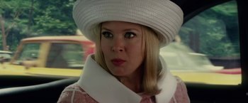 Movie still from “Down with Love” (2003), directed by Peyton Reed – A person wearing a hat; Close Up shot, Over the shoulder angle