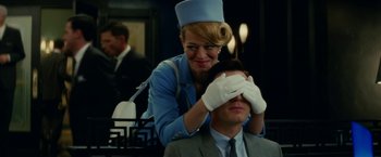 Movie still from “Down with Love” (2003), directed by Peyton Reed – A man and a woman in a blue suit and white gloves; Close Up shot, Over the shoulder angle