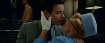 Movie still from “Down with Love” (2003), directed by Peyton Reed – A man and a woman kissing on the cheek; Close Up shot, Low angle