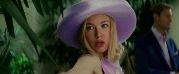 Movie still from “Down with Love” (2003), directed by Peyton Reed – A woman wearing a purple hat and a purple dress; Close Up shot, Low angle