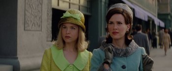 Movie still from “Down with Love” (2003), directed by Peyton Reed – Two women wearing hats and gloves standing next to each other; Close Up shot, Low angle