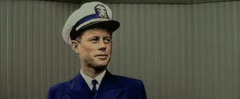 Movie still from “Down with Love” (2003), directed by Peyton Reed – A wax figure of a man wearing a uniform and wearing a hat; Close Up shot, Low angle