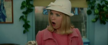 Movie still from “Down with Love” (2003), directed by Peyton Reed – A woman wearing a white hat and a pink jacket; Close Up shot, Low angle