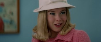 Movie still from “Down with Love” (2003), directed by Peyton Reed – A woman with blonde hair wearing a white hat; Close Up shot, Over the shoulder angle