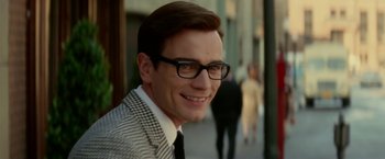 Movie still from “Down with Love” (2003), directed by Peyton Reed – A person wearing glasses and a suit; Close Up shot, Over the shoulder angle