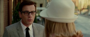 Movie still from “Down with Love” (2003), directed by Peyton Reed – A man in a suit and a white hat; Close Up shot, Over the shoulder angle