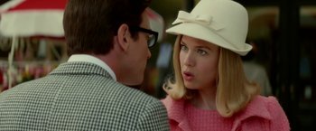 Movie still from “Down with Love” (2003), directed by Peyton Reed – A man and a woman wearing a white hat; Close Up shot, Over the shoulder angle