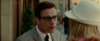 Movie still from “Down with Love” (2003), directed by Peyton Reed – A person wearing a suit and glasses; Close Up shot, Over the shoulder angle