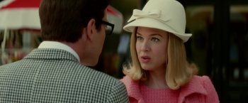 Movie still from “Down with Love” (2003), directed by Peyton Reed – A woman wearing a white hat talking to a man wearing glasses; Close Up shot, Over the shoulder angle