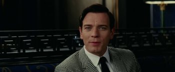 Movie still from “Down with Love” (2003), directed by Peyton Reed – A person wearing a suit and tie; Close Up shot, Over the shoulder angle