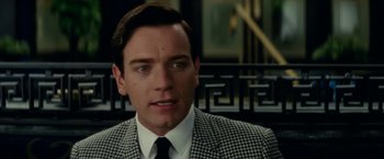 Movie still from “Down with Love” (2003), directed by Peyton Reed – A person wearing a suit and tie; Close Up shot, Over the shoulder angle