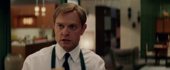 Movie still from “Down with Love” (2003), directed by Peyton Reed – A person wearing a shirt and a tie; Close Up shot, Over the shoulder angle