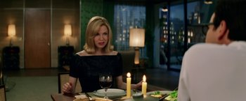 Movie still from “Down with Love” (2003), directed by Peyton Reed – A woman sitting at a table with a glass of red wine; Medium shot, Over the shoulder angle
