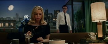Movie still from “Down with Love” (2003), directed by Peyton Reed – A man and a woman sitting in front of a cake; Medium shot, Over the shoulder angle