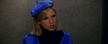 Movie still from “Down with Love” (2003), directed by Peyton Reed – A woman wearing a blue hat and a black sweater; Close Up shot, Over the shoulder angle