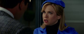 Movie still from “Down with Love” (2003), directed by Peyton Reed – A woman wearing a blue jacket and a blue hat; Close Up shot, Over the shoulder angle