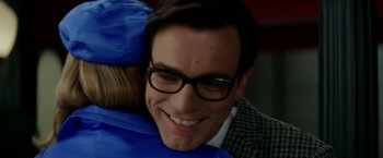 Movie still from “Down with Love” (2003), directed by Peyton Reed – A person wearing glasses and smiling; Close Up shot, Over the shoulder angle