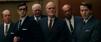 Movie still from “Down with Love” (2003), directed by Peyton Reed – A group of men standing next to each other in a room; Medium shot, Low angle