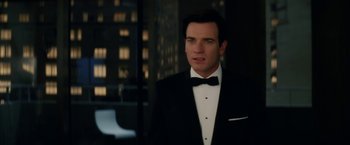 Movie still from “Down with Love” (2003), directed by Peyton Reed – A man in a tuxedo standing in front of a building; Close Up shot, Over the shoulder angle