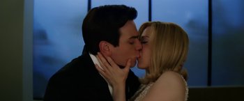 Movie still from “Down with Love” (2003), directed by Peyton Reed – A man and a woman kissing each other in front of a window; Close Up shot, Low angle