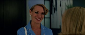 Movie still from “Down with Love” (2003), directed by Peyton Reed – A woman wearing a blue hat smiling for the camera; Close Up shot, Low angle