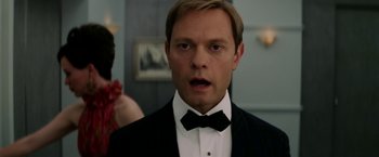 Movie still from “Down with Love” (2003), directed by Peyton Reed – A person wearing a suit and a bow tie; Close Up shot, Over the shoulder angle