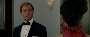 Movie still from “Down with Love” (2003), directed by Peyton Reed – A man in a tuxedo looking at a woman in a red dress; Close Up shot, Over the shoulder angle