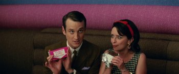 Movie still from “Down with Love” (2003), directed by Peyton Reed – A man and a woman sitting next to each other; Close Up shot, High angle