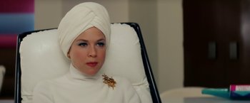 Movie still from “Down with Love” (2003), directed by Peyton Reed – A woman in a white turban sitting in a chair; Close Up shot, Over the shoulder angle