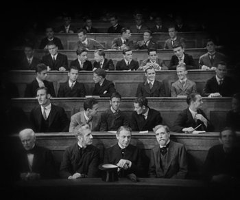 Movie still from “Dr. Jekyll and Mr. Hyde” (1931), directed by Rouben Mamoulian – A group of men sitting in a lecture hall; Wide shot, High angle