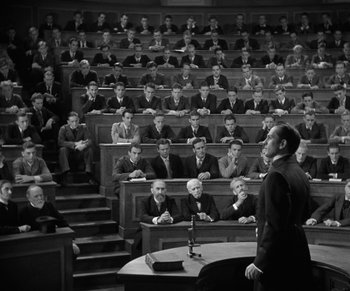 Movie still from “Dr. Jekyll and Mr. Hyde” (1931), directed by Rouben Mamoulian – A man is speaking in front of a group of people; Extreme Wide shot, High angle