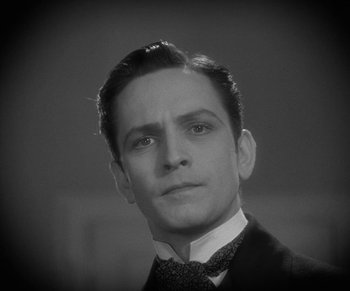 Movie still from “Dr. Jekyll and Mr. Hyde” (1931), directed by Rouben Mamoulian – A black and white photo of a man in a suit and tie; Close Up shot, Low angle