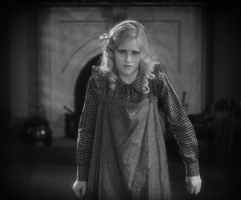 Movie still from “Dr. Jekyll and Mr. Hyde” (1931), directed by Rouben Mamoulian – A young girl is standing in front of a fireplace; Medium shot, High angle