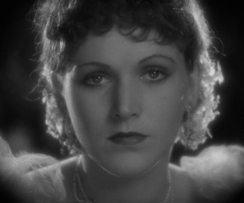 Movie still from “Dr. Jekyll and Mr. Hyde” (1931), directed by Rouben Mamoulian – An old photo of a woman in a white dress; Close Up shot, High angle