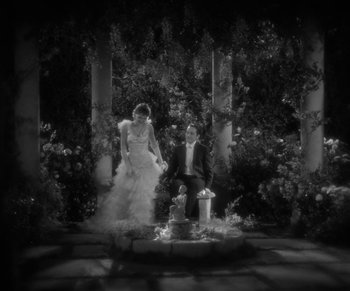 Movie still from “Dr. Jekyll and Mr. Hyde” (1931), directed by Rouben Mamoulian – A black and white photo of a man and a woman; Wide shot, High angle