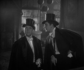 Movie still from “Dr. Jekyll and Mr. Hyde” (1931), directed by Rouben Mamoulian – Two men in top hats are standing next to each other; Medium shot, Low angle