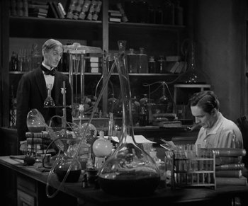 Movie still from “Dr. Jekyll and Mr. Hyde” (1931), directed by Rouben Mamoulian – A man and a woman working in a lab; Medium shot, High angle
