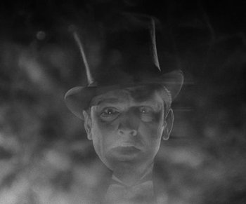 Movie still from “Dr. Jekyll and Mr. Hyde” (1931), directed by Rouben Mamoulian – A black and white photo of a man wearing a top hat; Close Up shot, Low angle